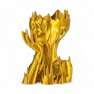 May include: A gold-coloured sculpture of a human head with dripping liquid, resembling melted wax. The sculpture has a detailed face and hands, and the liquid forms a unique and abstract design.
