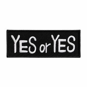 May include: A rectangular black patch with the embroidered text "YES or YES" in white. The patch has a stitched border and is set against a white background. The text is in a simple, sans-serif font.