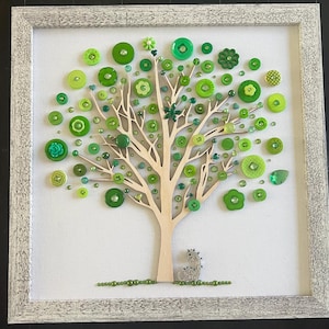 May include: A framed green button art piece depicting a tree with a small green button squirrel at the base. The tree is made of wood and the leaves are made of green buttons of various sizes and shapes.