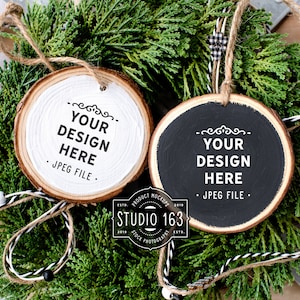 May include: Two round wooden ornaments, one white and one black, with the text "YOUR DESIGN HERE" in a decorative font. The ornaments are hanging with twine and are surrounded by greenery. The text "JPEG FILE" is also visible.