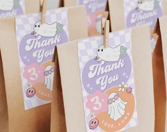 May include: Kraft paper gift bags with decorative tags. Each tag features a ghost illustration, the words "Thank You," and the number "3." The tags are secured with wooden clothespins. The overall design has a retro, whimsical aesthetic.