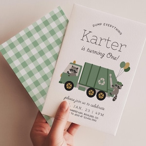 May include: A birthday invitation featuring a green garbage truck with raccoons and balloons. The invitation reads "Karter is turning One!" and includes event details. The envelope has a green and white gingham pattern.