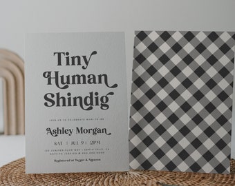 May include: A baby shower invitation with a black and white gingham pattern background. The invitation reads "Tiny Human Shindig" and includes the name "Ashley Morgan", the date "Sat Jul 9 | 2PM", the address "125 Juniper Plum Way | Santa Cruz, CA", and the RSVP information "RSVP to Jessica 500.000.0000". The invitation also states "Registered at Target & Amazon".