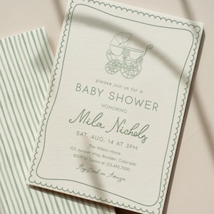 May include: Baby shower invitation featuring a light green stroller illustration and text. The invitation reads "Baby Shower" and honours Mila Nichols. The invitation has a scalloped border and is paired with a striped card.