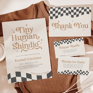 May include: A baby shower invitation with a checkered pattern and the text "Tiny Human Shindig" in gold lettering. The invitation includes the name "Kendall Clarkson" and details for the event. There are also cards for a diaper raffle and books for baby.