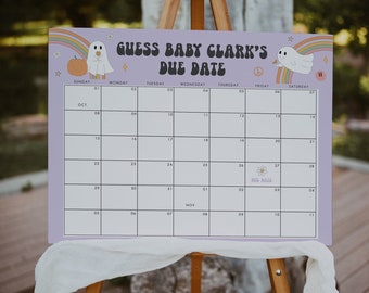 May include: A light purple baby shower calendar with the text "GUESS BABY CLARK'S DUE DATE". The calendar features a rainbow, ghost, and pumpkin graphic. The calendar is displayed on a wooden easel.