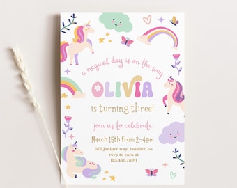 May include: A white invitation card with a rainbow, stars, flowers, and unicorns. The text reads "a magical day is on the way Olivia is turning three! join us to celebrate March 15th from 2-4pm 375 juniper way, boulder, co rsvp to cara at 123.456.7890"