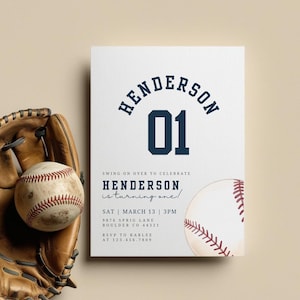 May include: A baseball-themed invitation with the name "Henderson" and the number "01" in navy blue. The text reads "Swing on over to celebrate Henderson is turning one!" A baseball and glove are in the image.