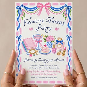 May include: A rectangular party invitation featuring a pink and blue bow border with watercolour illustrations of books, a cocktail, cake, flowers, perfume, and jewellery. The text reads Favourite Things Party, Hosted by Courtney & Alexis, Saturday, December 10 at 5pm, 123 Juniper Way, Santa Barbara, Ca. Bring 3 of the same $25 favourite thing, and leave with 3 new favourites! RSVP to Courtney at 123.456.7890.
