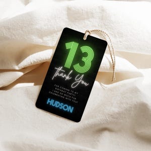 May include: A black gift tag with a neon green "13" and the words "Thank You". The tag includes the text "For coming to my birthday party! I had so much fun celebrating with you!" and the name "HUDSON".