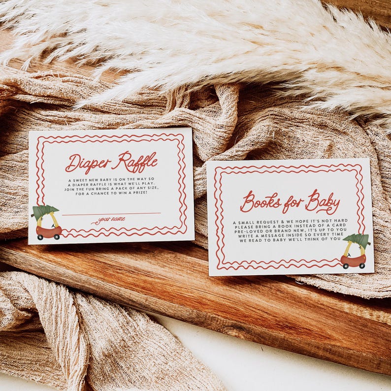 May include: Two red and white cards with wavy borders. The top card says "Diaper Raffle" and the bottom card says "Books for Baby". Both cards have a small illustration of a red wagon with a Christmas tree and a baby inside.