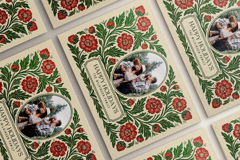 May include: Christmas cards with a cream background, featuring a family photo within an oval frame. The cards are decorated with a floral design in red and green, with the words "HAPPY HOLIDAYS" and "THE WILKINSON FAMILY" printed on them.