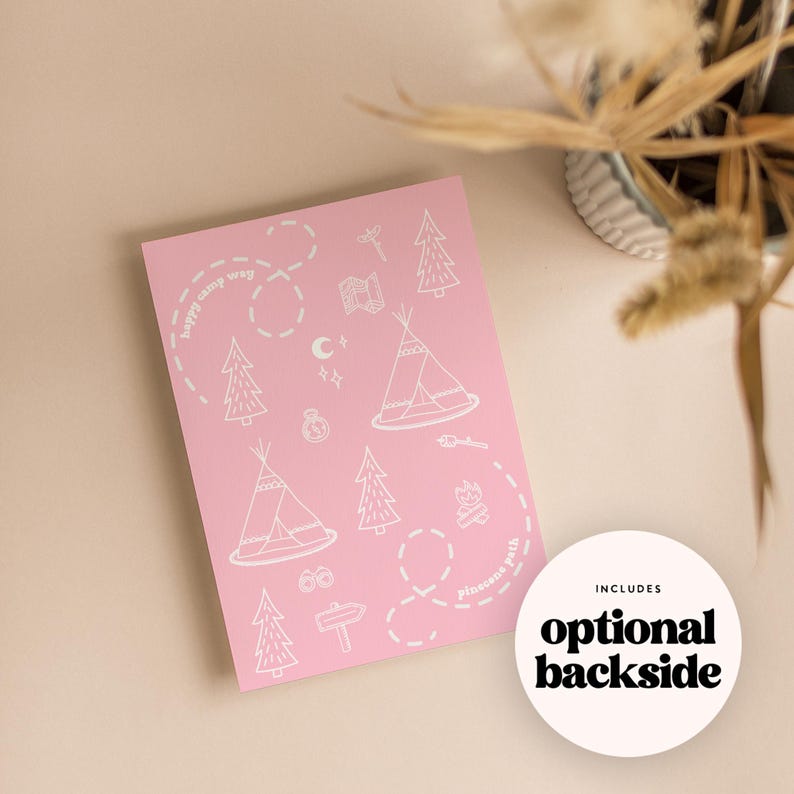 May include: A pink card with white illustrations of camping elements, including teepees, trees, and a campfire. The text "happy camp way" and "pincusue path" are written on the card. A white circle with the text "optional backside" is also present.