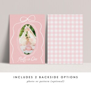 May include: Pink invitation card with a white bow design and an oval frame. The frame contains a photo of a baby. The text "Holly is One" is written in white script. The backside has a pink and white gingham pattern.