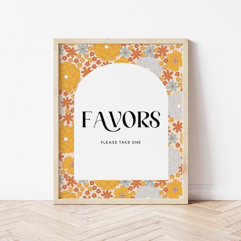 May include: A printable sign with a floral pattern in shades of yellow, orange, and blue. The sign says "Favors" in a black serif font and "Please take one" in a smaller font. The sign is framed in a light wood frame.