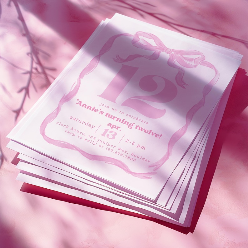 May include: A stack of pink and white birthday invitations. The invitations feature a large number 12, a bow, and the text "Annie's turning twelve!" with event details. The background is a soft pink.