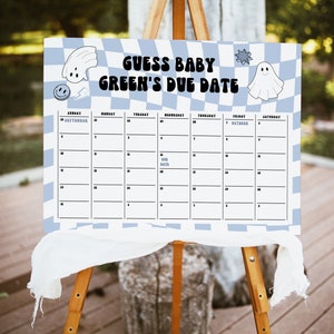 May include: A baby shower sign on a wooden easel. The sign has a blue and white checkered background with the text "GUESS BABY GREEN'S DUE DATE". It includes a calendar grid with the month of September and October. Decorative ghost and star graphics are included.