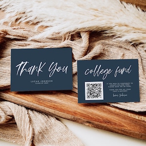 May include: Two navy blue cards with white script. One card reads "Thank You" and the other says "college fund" with a QR code. The cards are on a wooden surface with a beige fabric.