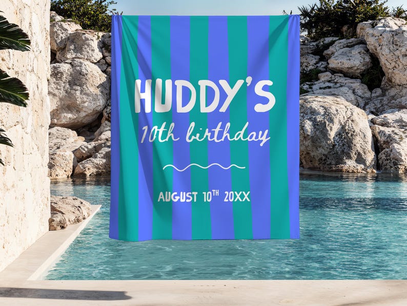 May include: A rectangular fabric banner featuring vertical stripes in alternating shades of bright blue and teal. The white text reads HUDDY'S 10th birthday, followed by a horizontal wavy line and the date AUGUST 10th 20XX printed in white.