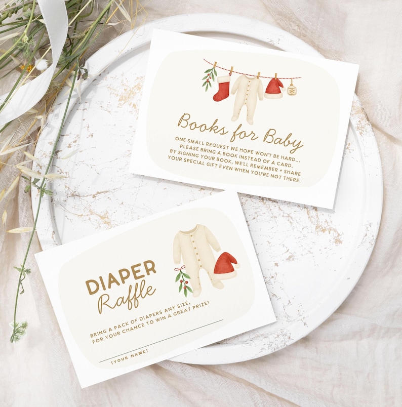 May include: Two baby shower invitation cards. One card reads "Books for Baby" with text and illustrations of baby clothes. The other card reads "Diaper Raffle" with text and illustrations of baby clothes.