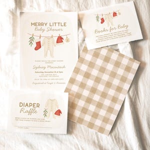 May include: A set of baby shower stationery with a festive design. The invitations and inserts include the phrases "Merry Little Baby Shower", "Diaper Raffle", and "Books for Baby". The design includes illustrations of baby clothes.