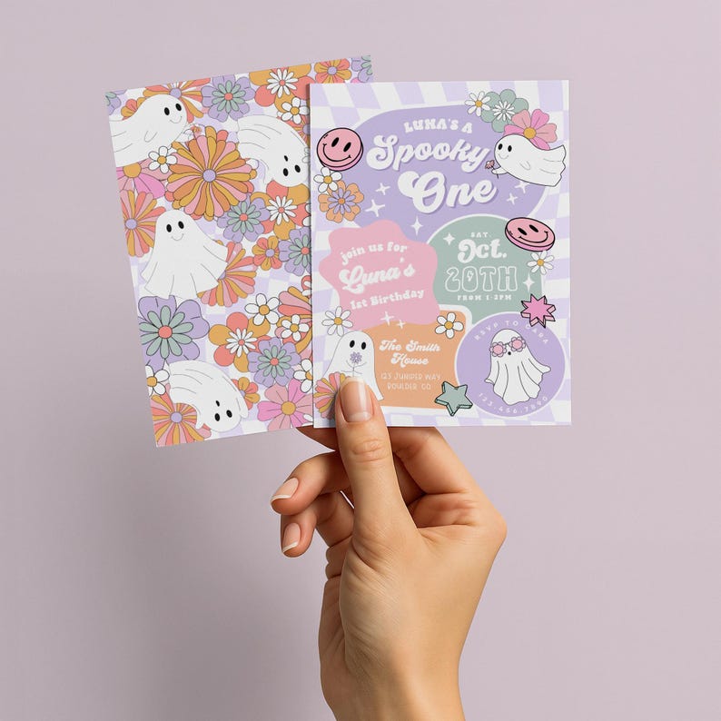 May include: Two invitation cards with a spooky theme. One card features a floral pattern with ghost illustrations. The other card has the text "Luka's a Spooky One" and "Oct. 20th" with ghost and smiley face graphics. The cards are held by a hand.