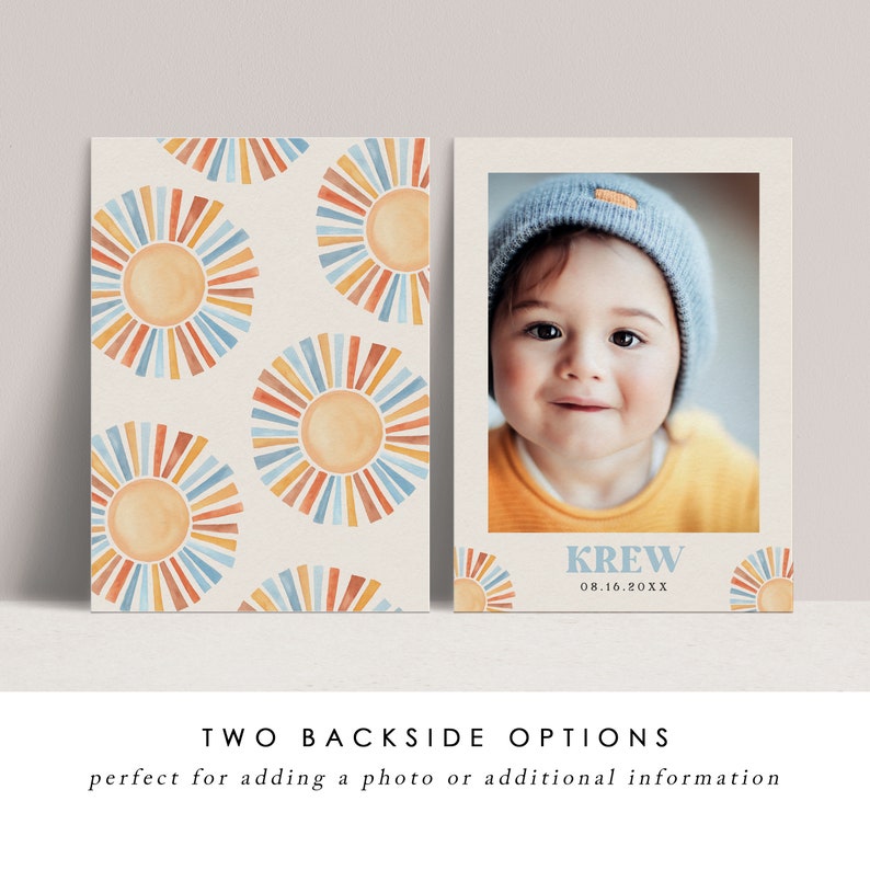May include: Two-sided invitation or announcement card. One side features a photo of a baby wearing a blue hat and orange shirt. The other side has a repeating pattern of watercolor suns in orange, blue, and yellow. The card includes the name "KREW" and a date.