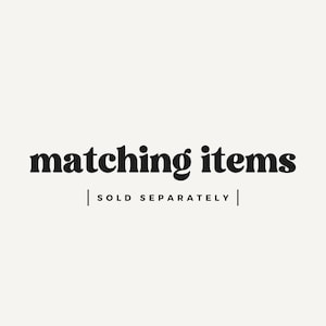 May include: Image with the text "matching items" in a bold, black font. Below the text is the phrase "SOLD SEPARATELY" in a smaller, black font, separated by vertical lines. The background is a solid, off-white color.