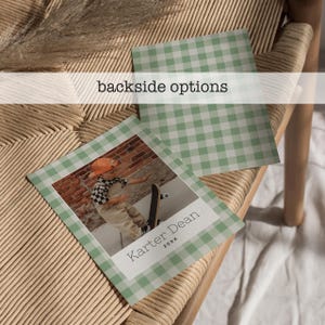 May include: Two square cards with a green and white gingham border. One card features a photo of a child with a skateboard, the text "Karter Dean" and "20XX". The other card has a gingham pattern. The text "backside options" is above the cards.