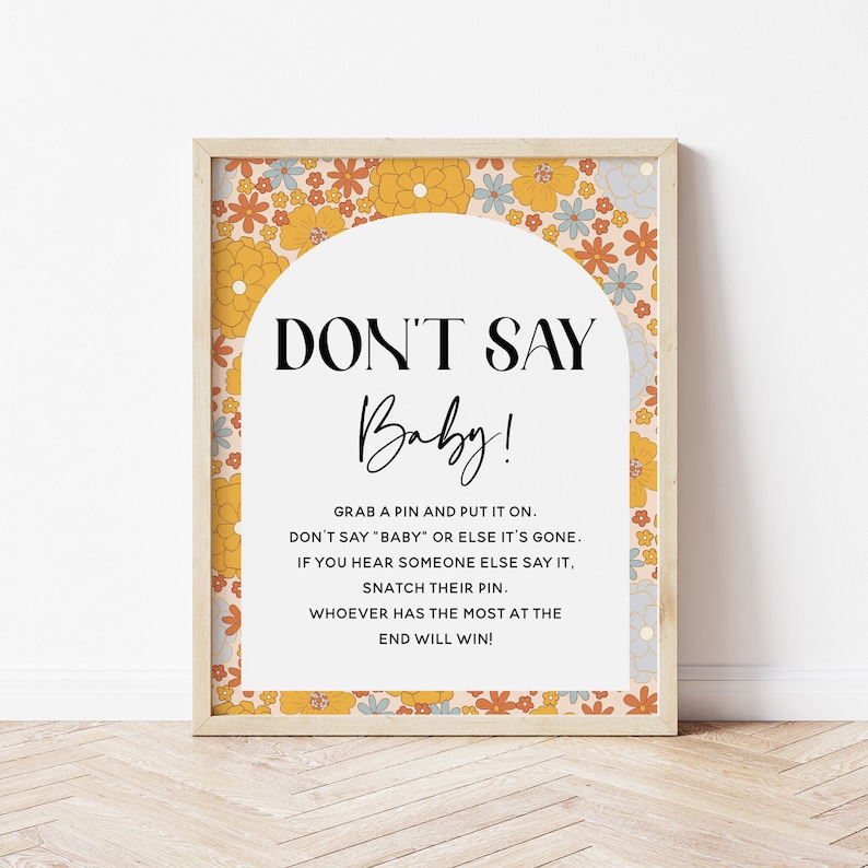 May include: A printable sign with a floral border and an archway design. The sign says "Don't Say Baby!" and includes instructions for a game where guests must avoid saying the word "baby".