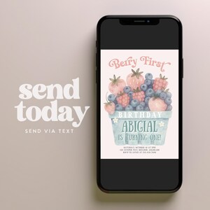 May include: A smartphone displays a birthday invitation with a watercolor illustration of berries in a basket. The text reads "Berry First Birthday" and "Abigail is turning one!" The invitation includes event details.
