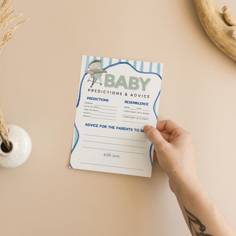 May include: A baby shower game card with blue accents and the word "BABY" at the top. The card includes sections for predictions and advice, with a small illustration of a grill. The text "PREDICTIONS & ADVICE" is also visible.