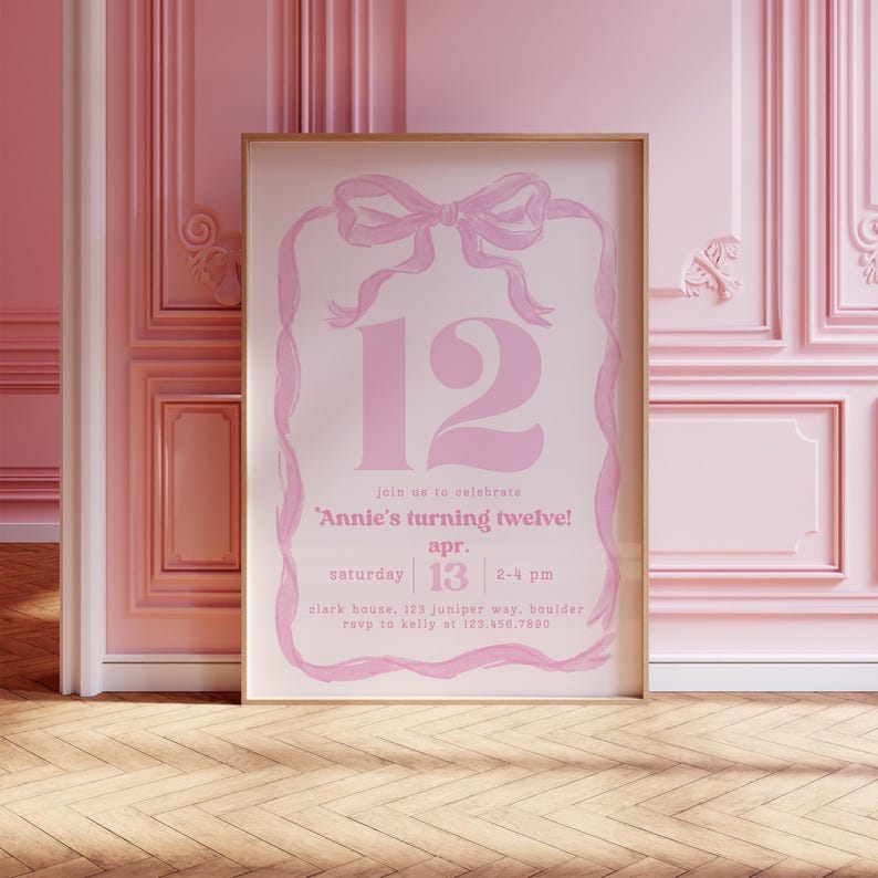 May include: A framed pink invitation with a bow and ribbon design. The number 12 is prominently displayed, with text that reads "Annie's turning twelve!" and details for the event, including the date, time, and location.
