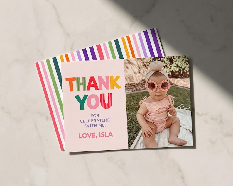 May include: A rectangular thank you card featuring a light pink background with the text THANK YOU FOR CELEBRATING WITH ME! LOVE, ISLA in colorful letters. The card includes a photo of a child wearing a pink outfit and flower-shaped sunglasses.