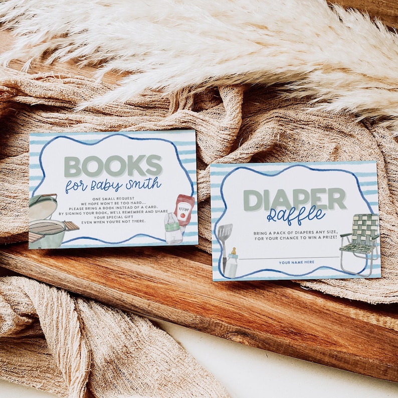 May include: Two rectangular baby shower cards with blue and white striped borders. One card reads "BOOKS for baby smith" with illustrations of a grill and condiments. The other card says "DIAPER Raffle" with a camping chair illustration.