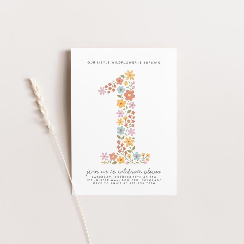 May include: A white invitation card with the text "OUR LITTLE WILDFLOWER IS TURNING" at the top. A large number "1" is filled with colorful flowers. Below, the text reads "join us to celebrate olivia" with event details.