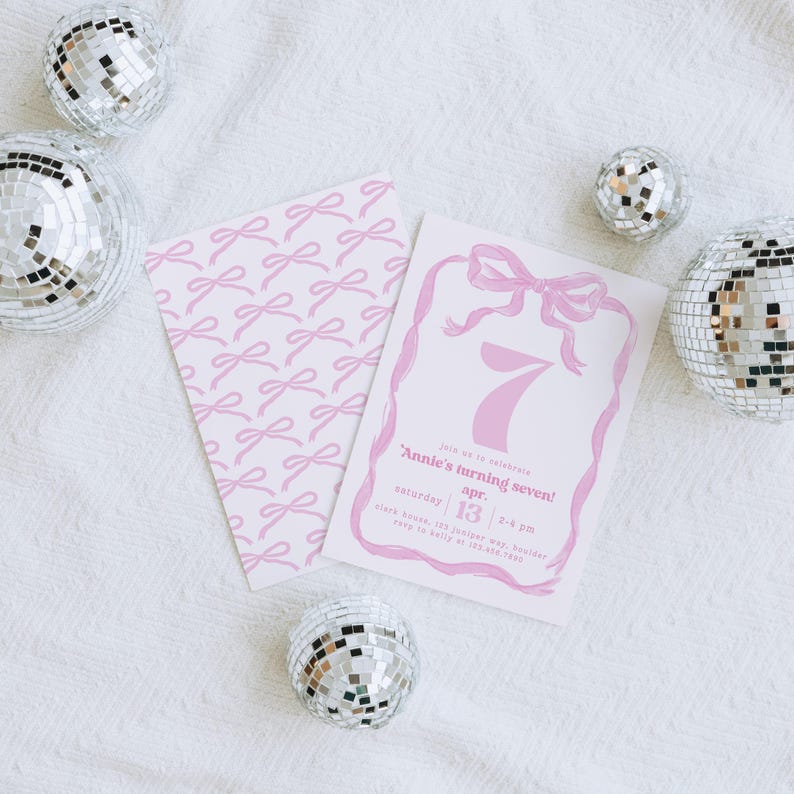 May include: Pink invitation with a pink bow and the number 7 for a birthday party. The text reads "Join us to celebrate Annie's turning seven! Saturday, April 13, 2-4 pm. Clark House, 123 Jasper Way. RSVP to Kelly at 555-789-1234."