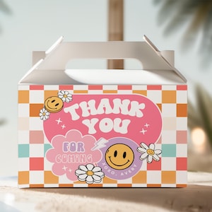 May include: A white favor box with a checkered pattern in pink, orange, and blue. The box has a handle and says "Thank You" in pink letters with a pink and white smiley face and the text "For Coming" in a pink cloud. The box also says "XOXO, Avery" in black letters.