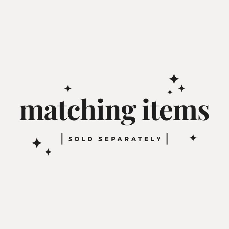May include: A graphic with the words "matching items" in a bold, serif font. Below the text is the phrase "SOLD SEPARATELY" in a smaller font. Decorative starbursts are scattered around the text on a cream background.