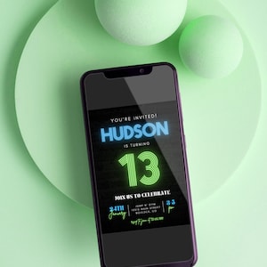 May include: A smartphone displays a digital invitation for Hudson's 13th birthday. The invitation features neon blue and green text on a black background. The phone rests on a light green surface with two matching spheres.