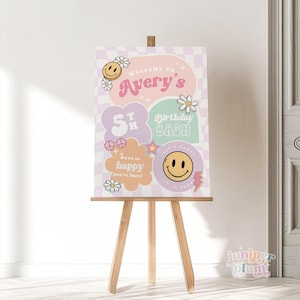 May include: A pink and green welcome sign for a 5th birthday party. The sign features a checkered background, smiley faces, and the text "Welcome to Avery's 5th Birthday Bash".