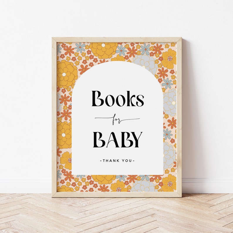 May include: A framed print with a floral pattern in shades of orange, yellow, and blue. The print features an arch with the text "Books for Baby - Thank You -" in black.