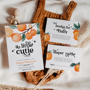 May include: A baby shower invitation with orange and green illustrations of oranges and leaves. The invitation reads "a little cutie is on the way" and includes the name Megan Whitmore and the date Saturday August 15th at 4pm. There are also two cards for a book and diaper raffle.