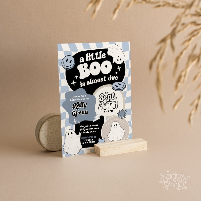 May include: A blue and white baby shower invitation with a ghost and the text "a little BOO is almost due". The invitation is for Kelly Green and is scheduled for September 20th at 3 PM. The address is 122 Juniper Way, Boulder, CO. The invitation also includes a note about registering at Target and Amazon.