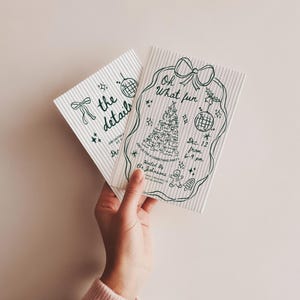 May include: Two Christmas party invitations with green line art on a striped background. One invitation says "the details" and the other says "Oh What fun" with a Christmas tree and disco ball illustration. The invitations are held by a person.