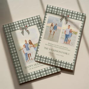 May include: Two holiday cards with family photos. The cards have a green and white gingham border and a decorative bow. The text on the cards reads "Wishing you love, joy & peace this holiday season and year to come!" and "HAPPY HOLIDAY".