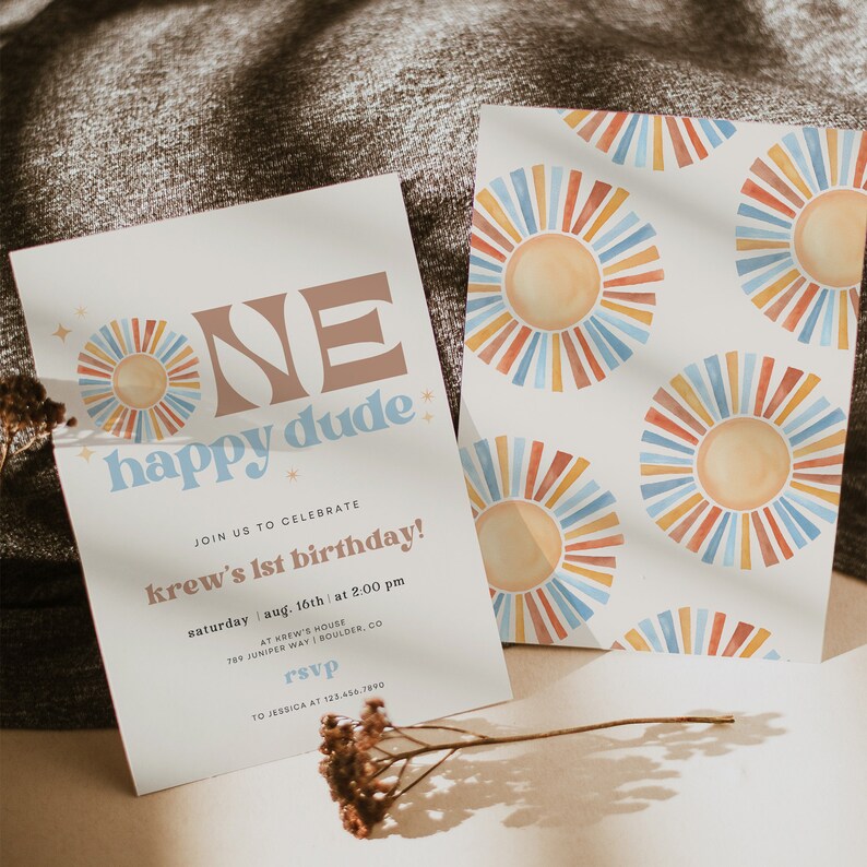 May include: Two birthday party invitations. The main invitation has the text "ONE happy dude" in brown and blue. The invitation includes the party details. The second invitation has a repeating pattern of colorful sunburst designs.