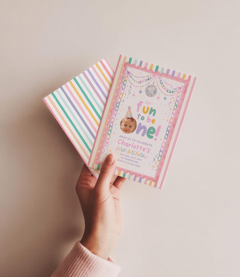 K&ouml;nnte beinhalten: Eine rechteckige Geburtstagseinladungskarte mit pastellfarbenem Streifenrand, einer Discokugel-Illustration und dem Text "fun to be one!". Die Karte enth&auml;lt ein kreisf&ouml;rmiges Foto eines Kindes mit Partyhut sowie die Veranstaltungsdetails f&uuml;r den ersten Geburtstag.