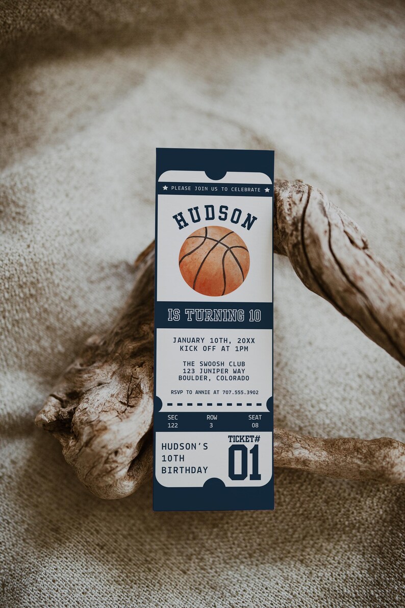 May include: A blue and white ticket-style invitation for a basketball-themed birthday party. The invitation features a basketball graphic and the text "Hudson is turning 10". The invitation also includes the date, time, location, and RSVP information.