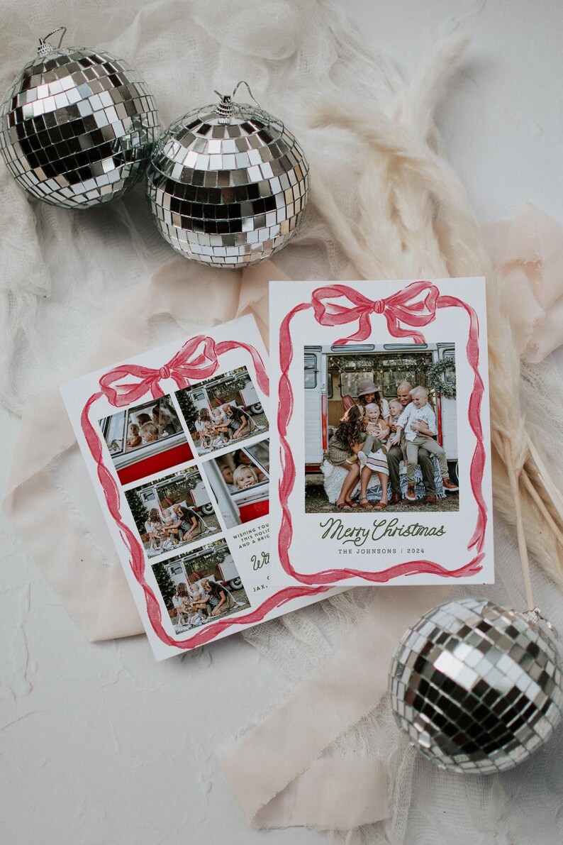 May include: Two silver disco balls and two Christmas cards. The cards feature family photos inside a red watercolour bow frame. One card says "Merry Christmas" and "The Johnsons | 2024". The other card has multiple photos and text.